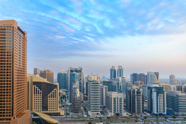 Skyline of Dubai with modern high-rise buildings under a clear blue sky, illustrating urban life in the UAE.