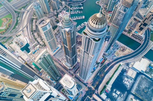 Aerial view of skyscrapers and waterways in Binghatti Hills, showcasing its high-rise real estate offerings.